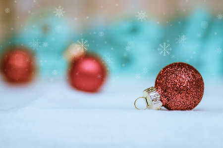 Christmas decoration: Close up of red Christmas baubles, advent calendar in the blurry background