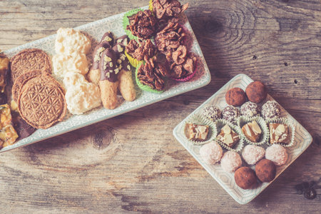 Closeup of variety of traditional European homemade Christmas cookies on rustic wooden deskの写真素材