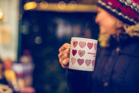 Girl is drinking mulled wine on the Christmas market, funの写真素材