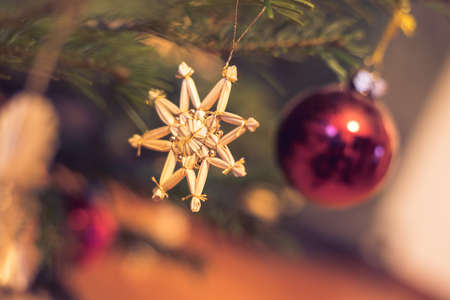 Cut-out of a traditionally decorated Christmas tree with Christmas baubles.
