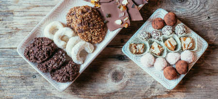 Closeup of variety of traditional European homemade Christmas cookies on rustic wooden deskの写真素材