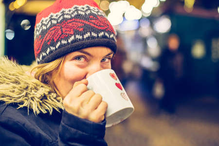 Girl is drinking mulled wine on the Christmas market, funの写真素材