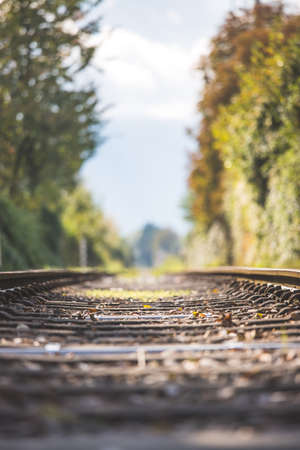 Landscape of an old abandoned railway in fall. Warm light, sustainable travelingの写真素材