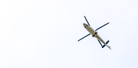 Helicopter in the sky, white cloudsの写真素材