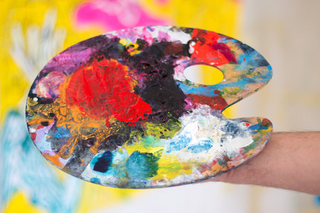 Artist holding colorful color palette. Painting therapy.の写真素材