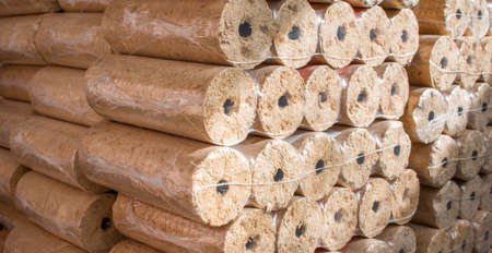 Wood briquettes for heating, packed in plastic filmの写真素材