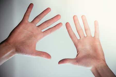 Young male hands making a healing or protecting gestureの写真素材
