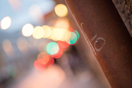 Closeup of rain drain, urban city lights in the blurry backgroundの写真素材