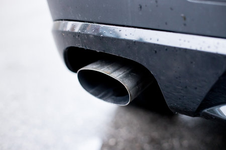Close up of an exhaust pipe of a car, environmental pollutionの写真素材