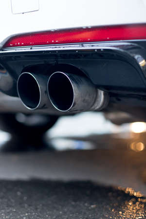 Close up of an exhaust pipe of a car, environmental pollutionの写真素材