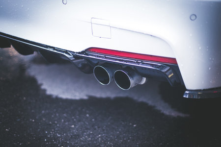 Close up of an exhaust pipe of a car, environmental pollutionの写真素材