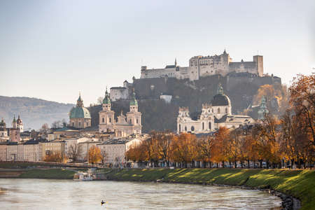 Salzburg historic district and the river salzach in autumn time, colorful leaves and colors with sunshine, Austriaのeditorial素材