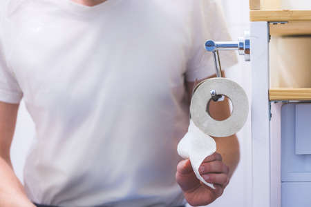 Hand of a male person using toilet paperの写真素材