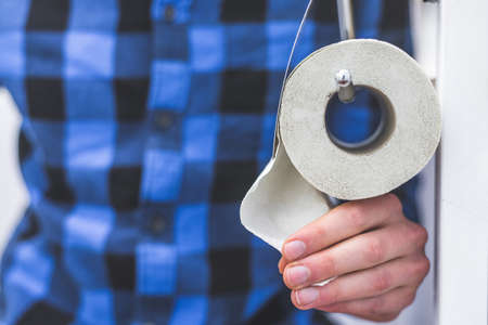 Hand of a male person using toilet paperの写真素材