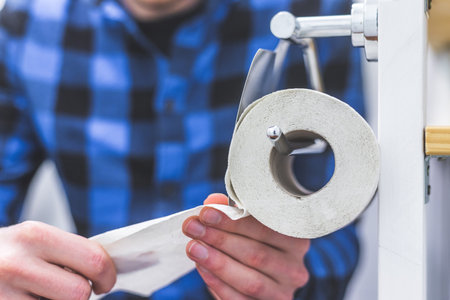 Hand of a male person using toilet paperの写真素材
