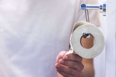 Hand of a male person using toilet paperの写真素材