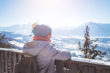 Back of young woman enjoying the view over the mountains, outlook. Gaisberg, Austriaの写真素材