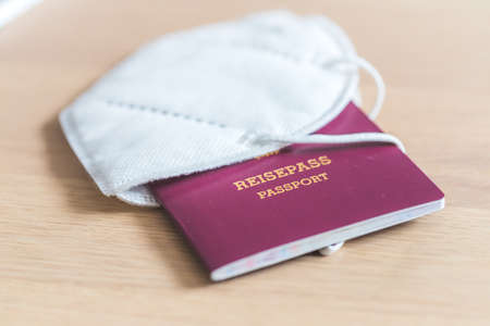 Close up of passport for traveling, airport, âReisepass Passportâ, ffp2 protection maskの写真素材