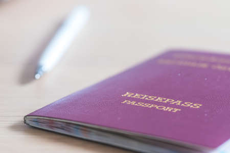 Close up of fingers holding a passport for traveling, airport, "Reisepass Passport"の写真素材