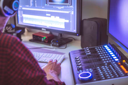 Video editing, recording and cutting room with monitors and sound mixing deskの写真素材