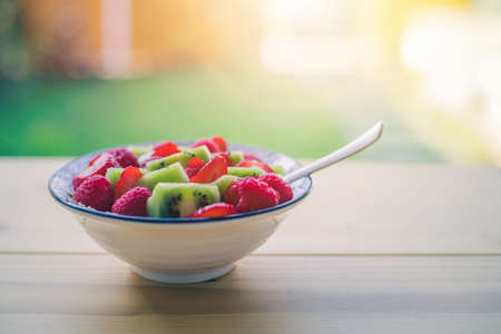 Close up of strawberries and kiwis in a ceramic bowlの写真素材