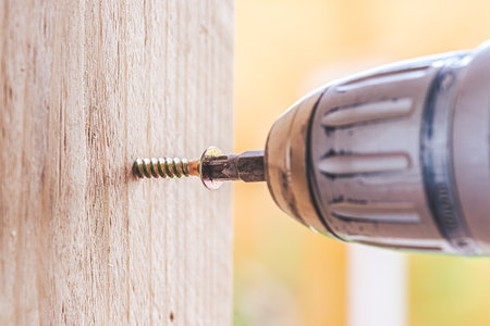 Close up of screw and screwing machine, workshopの写真素材