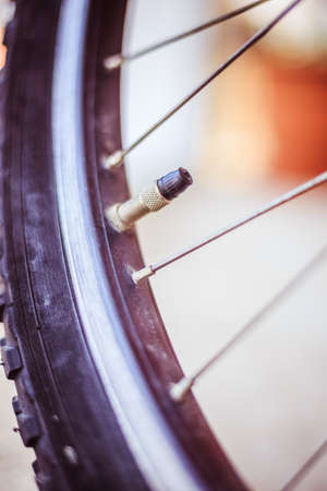 Close up picture of a bike tire outlet and spokes, blurry backgroundの写真素材