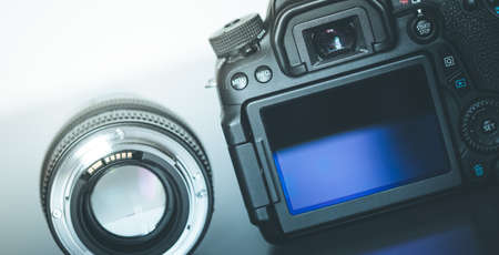 Back view of a professional reflex camera with flip lsd screen and a photo lensの写真素材