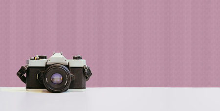 Retro vintage photography camera on red colored backgroundの写真素材