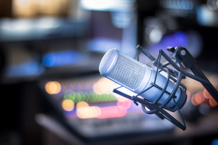 Microphone in a professional recording or radio studio, equipment in the blurry backgroundの写真素材