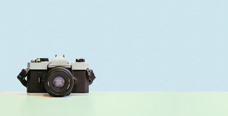 Retro vintage photography camera on blue colored background