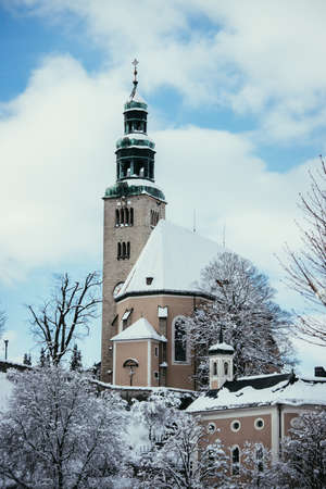 Snowy church in Salzburg, MÃ¼llnerkircheの写真素材