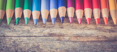 Set of multi-colored pencils on a rustically wooden table, copy spaceの写真素材