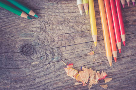 Set of multi-colored pencils on a rustically wooden table, copy spaceの写真素材