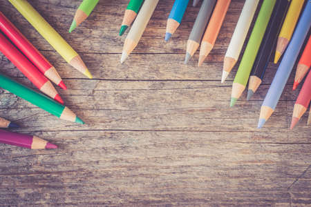 Set of multi-colored pencils on a rustically wooden table, copy spaceの写真素材