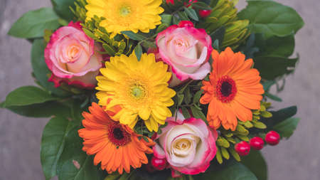 Close up of spring flower bouquet with gerbera and rosesの写真素材