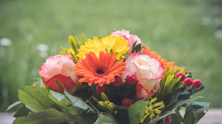 Close up of spring flower bouquet with gerbera and rosesの写真素材