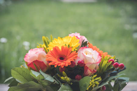 Close up of spring flower bouquet with gerbera and rosesの写真素材