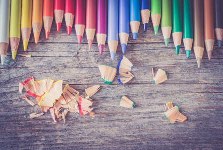 Set of multi-colored pencils on a rustically wooden table, copy spaceの写真素材