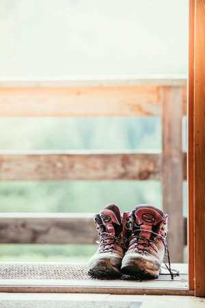 Hiking boots on rustic wood floor in an abandoned mountain chalet in Austriaの写真素材