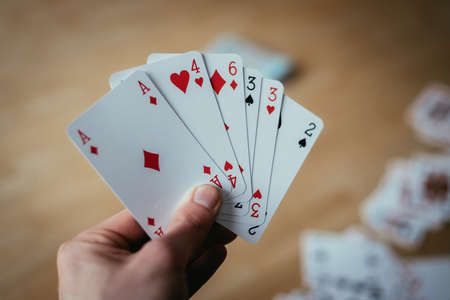 Young man is playing cards, cutout of his hands
