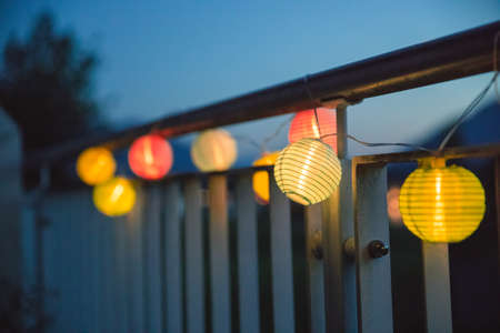 Colorful lampions outside, twilight hour, garden partyの写真素材