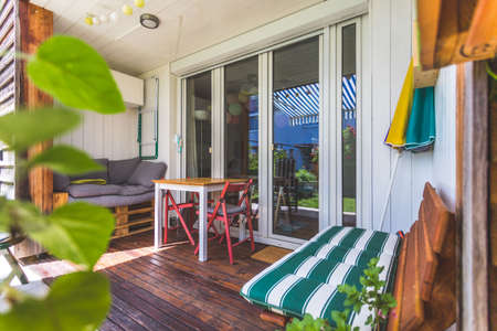 Cozy veranda with little green garden, summer time