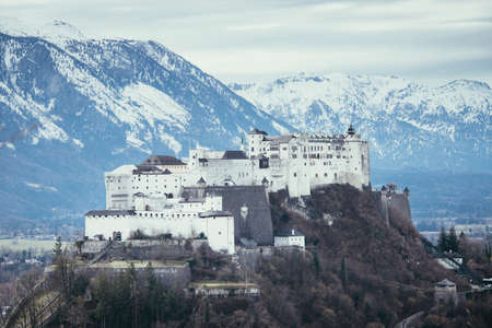 Fortress Hohensalzburg with snowy mountains in the background, autumn timeのeditorial素材