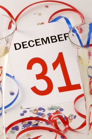 Calendar page between two glasses of champagne and New Yearの写真素材