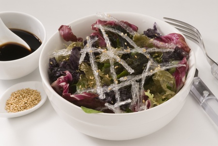 Assorted edible seaweed salad in a white bowl  Selective focus の写真素材