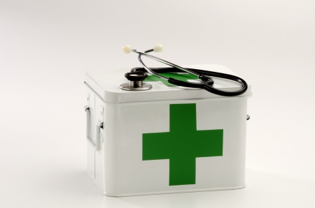 First aid box and a stethoscope in white backgroundの写真素材