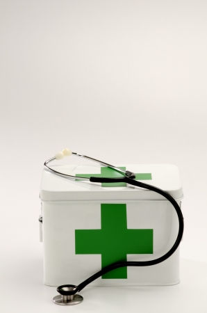 First aid box and a stethoscope in white backgroundの写真素材