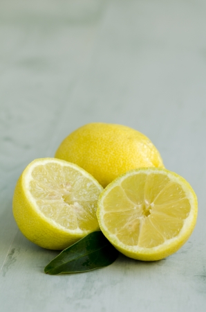 Lemons in a green wooden background. Selective focus. Taken in daylight.の写真素材
