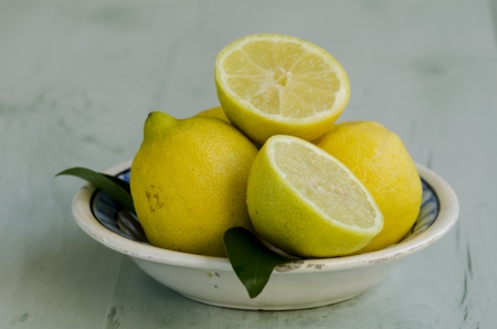 Lemons in an old ceramic plate. Selective focus. Taken in daylight.の写真素材